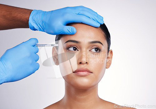 Image of Facial injection, beauty and skincare with woman, cosmetic treatment and filler isolated on studio background. Doctor hands, needle and female model face with dermatology, cosmetics and skin facelift