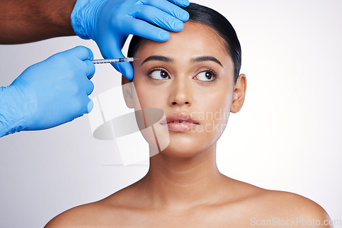 Image of Face injection, beauty and skincare with woman, cosmetic treatment and fillers isolated on studio background. Doctor hands, needle and female model with dermatology, cosmetics and skin facelift