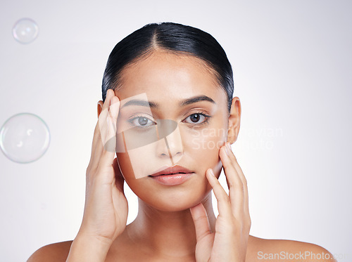 Image of Beauty, skin and woman with hands on face in studio for glow, dermatology or natural cosmetics. Portrait of aesthetic model person with bubbles for self care, facial or skincare on a white background