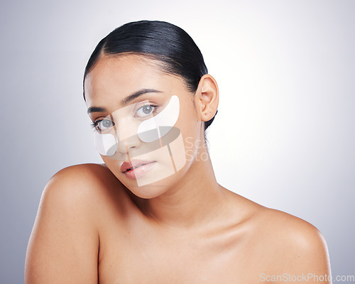 Image of Face, eye mask and beauty of a woman in studio for glow, dermatology or natural cosmetics. Portrait of model person with collagen skincare patch for facial self care or wellness on a white background