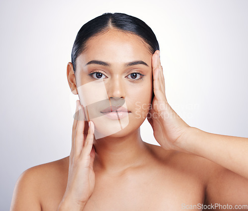 Image of Beauty, skin and woman with hands on face in studio for glow, dermatology or natural cosmetics. Headshot of aesthetic model person with self care, facial or skincare results on a white background