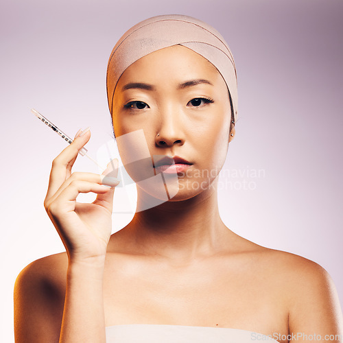 Image of Woman, portrait and plastic surgery with injection, bandage and asian model in studio background. Serious woman, syringe and face with collagen for aesthetic, cosmetics and facial beauty treatment.