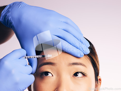 Image of Face skincare, forehead injection and Asian woman in studio isolated on a white background. Cosmetics, syringe and female model with collagen filler, dermatology and prp facelift in plastic surgery.