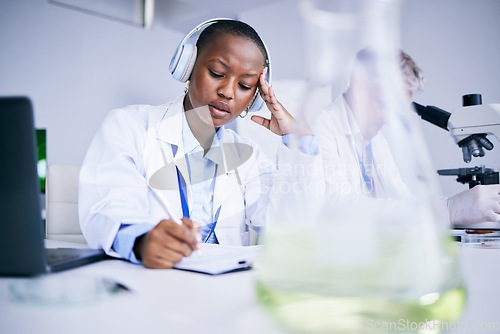 Image of Science, tired and black woman with a headache, writing or burnout with health issue, overworked and fatigue. Female person, employee or scientist with a migraine, stress or overtime with frustration