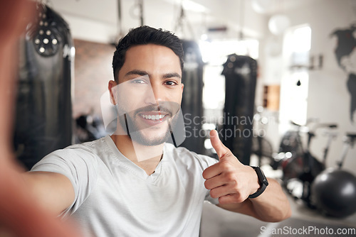 Image of Man, portrait and selfie at a gym for fitness with thumbs up for wellness or health in a close up. Male person, selfies and workout with happiness for training or exercise at a club for video call.