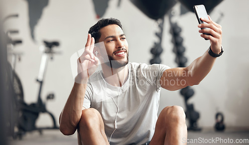 Image of Man, gym and selfie with happiness for exercise with motivation and wellness with peace sign. Male person, training and video call for a workout for sports and conversation with smile at a club.