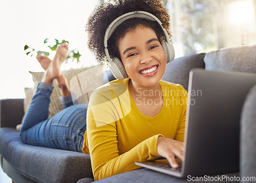 Image of Laptop, headphones and woman portrait on sofa for e learning, online education and music streaming on website service. Happy student or african person on couch, audio technology and computer for home