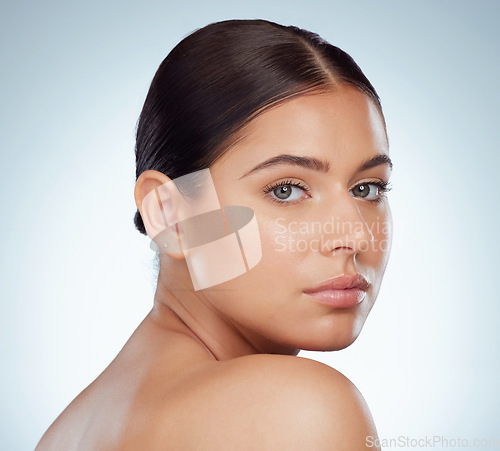 Image of Face, skincare and beauty of serious woman in studio isolated on a white background. Portrait, natural and female model in makeup, cosmetics or facial treatment for skin health, aesthetic or wellness