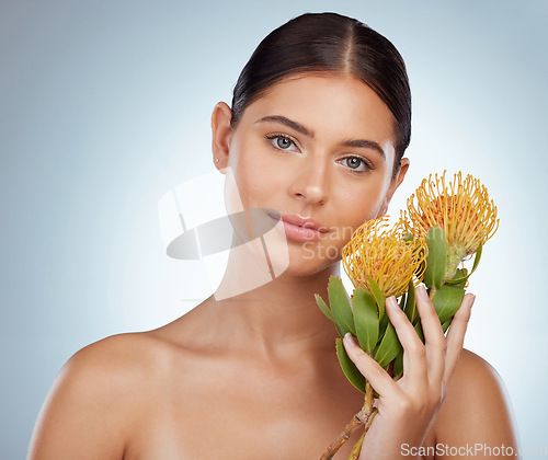 Image of Face, skincare and woman with protea flowers in studio isolated on a white background. Portrait, natural and female model with floral pincushion plants for makeup, cosmetics and beauty skin treatment