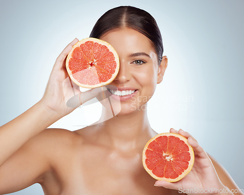 Image of Skincare, face and woman smile with grapefruit in studio isolated on a white background. Portrait, natural and female model with fruit for vitamin c, nutrition and healthy diet, wellness or cosmetics