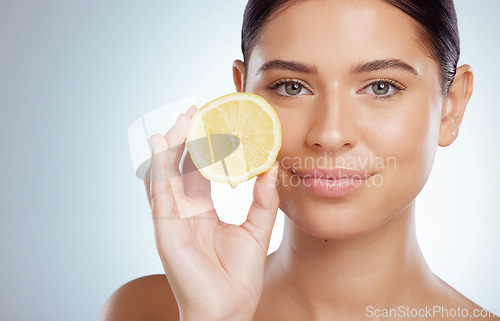 Image of Beauty skincare, face and woman with lemon in studio isolated on a white background. Portrait, natural or female model with fruit for vitamin c, vegan nutrition or healthy diet, wellness or cosmetics