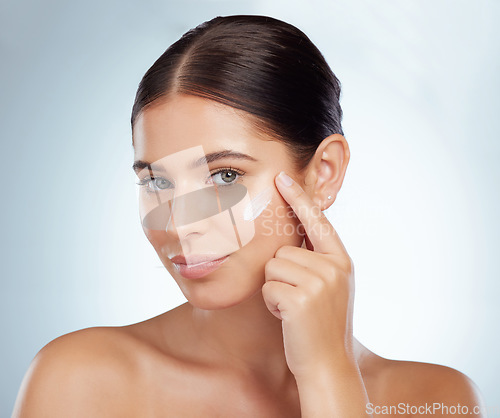 Image of Face, skincare and beauty of woman with cream in studio isolated on a white background. Portrait, dermatology lotion and female model apply cosmetics, sunscreen or moisturizer product for skin health