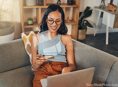 Image of Woman on sofa with laptop, credit card and online shopping, payment and ecommerce with fintech at home. Happy female customer at apartment, bank app and sale on store website with internet banking