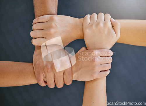 Image of Hands are together, link and support with solidarity closeup, team and motivation with community and connection. Top view of group huddle, collaboration and unity with respect, trust and teamwork