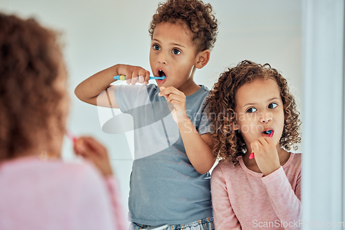 Image of Brushing teeth, mirror and dental with children in bathroom for morning, smile and cleaning. Oral hygiene, health and toothbrush with brother and sister in family home for wake up, mouth and results