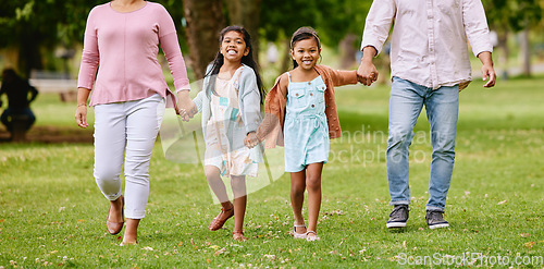 Image of Family, park and children holding hands with parents walking, bonding and time in nature together with smile. Mother, father and kids walk on grass field for fun outdoor adventure in garden or woods