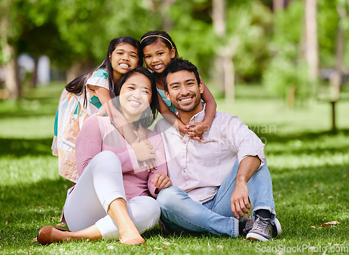 Image of Hug, portrait and asian family at a park smile, happy and having fun outdoor together. Face, love and children with parents on forest ground, sitting and embrace while enjoying nature on the weekend