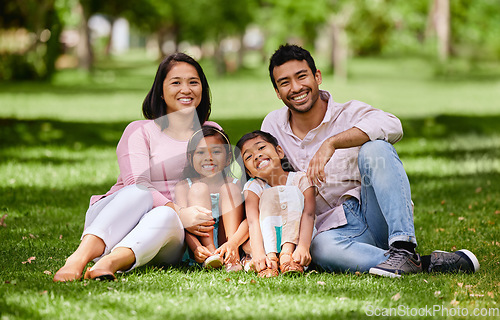 Image of Relax, portrait and asian family at a park happy, bonding and having fun outdoor together. Face, love and children with parents on forest ground, sitting and cheerful while enjoying nature on weekend