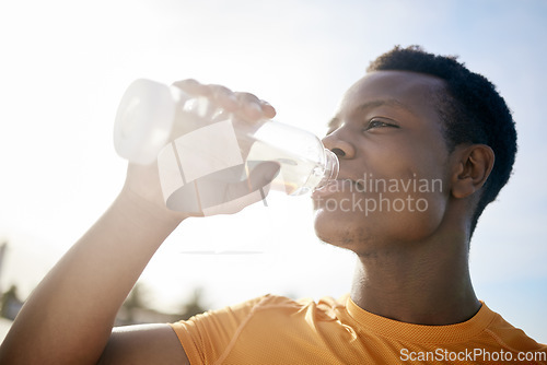 Image of Fitness, drink and black man with water bottle in exercise, training or outdoor cardio workout. Athlete, drinking and healthy hydration or person relax after running in summer sport practice