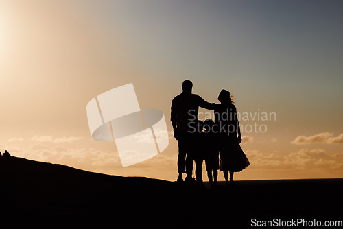 Image of Parents, kids and silhouette on mountain, sunset and hug with love, care and summer adventure. Mother, father and young children with sky background, space and outdoor on holiday, vacation or journey