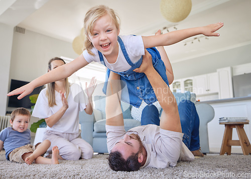 Image of Happy family, parents and children on carpet in living room playing, bonding and airplane game time. Home, love and playful energy, mom and dad with kids on floor, laughing and relax with happiness.