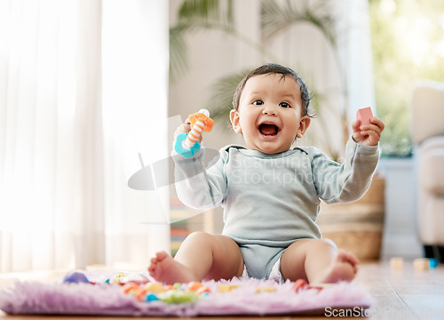 Image of Portrait, smile and happy baby with toys on floor for fun, playing and game at home. Face, excited and toddler boy with creative building blocks for child development, learning or play in living room