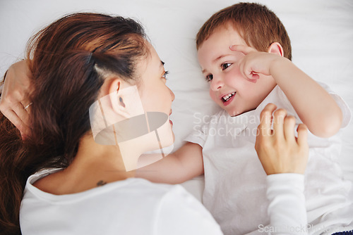 Image of Bed, relax and above mother and baby, bonding and talking, wake up and embracing in their home. Top view, love and parent with child in a bedroom, happy and sweet while enjoying the morning together