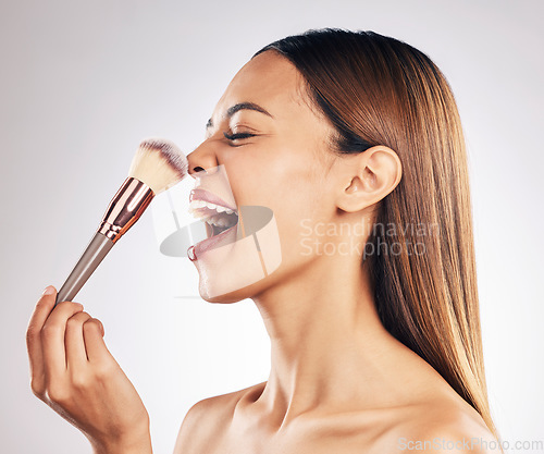 Image of Makeup, cosmetic and woman with a brush in studio with a natural, beauty and face routine. Glamour, cosmetology and female model laugh with cosmetics product for cheeks isolated by white background.