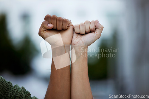 Image of Fist, protest and power by people in solidarity for justice, human rights and democracy on blurred background. Hands, diversity and men united for activism, change and transformation or community