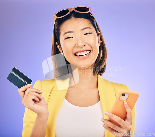 Image of Cellphone, card and portrait of a woman in studio for online shopping on ecommerce website. Happy, smile and Asian female model with internet banking for paying bills with phone by purple background.