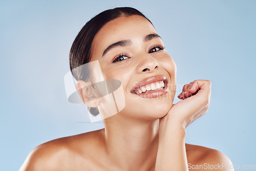 Image of Portrait, skincare and woman with cosmetics, smile and dermatology against blue studio background. Face, female person or model with salon treatment, luxury and grooming with foundation and aesthetic