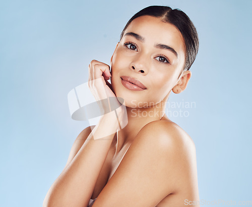 Image of Portrait, skincare and woman with cosmetics, beauty and grooming against a blue studio background. Face, female person and model with dermatology, luxury and spa treatment with wellness and pamper