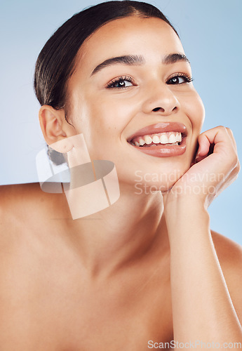 Image of Portrait, cosmetics and woman with dermatology, beauty and pamper treatment against a blue studio background. Face, female person or model with grooming, skincare and luxury with makeup and self care