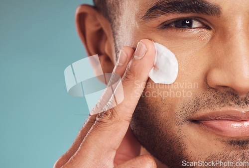 Image of Portrait, beauty and cream with a man in studio on a gray background to apply antiaging facial treatment. Face, skincare and lotion with a young male person indoor for wellness or aesthetic self care