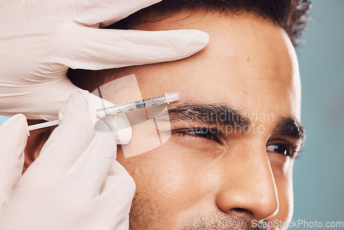 Image of Beauty, botox and eyebrow with a man in studio on a gray background for a plastic surgery injection. Hands, skincare and syringe with a young male person indoor for an antiaging facial filler closeup