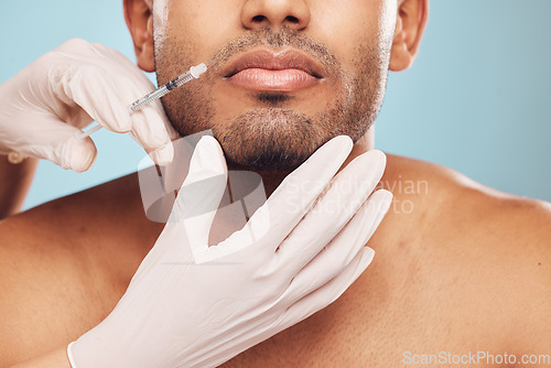 Image of Skincare, botox and mouth with a man in studio on a gray background for a plastic surgery injection. Hands, beauty and syringe with a young male person indoor for an antiaging facial filler closeup