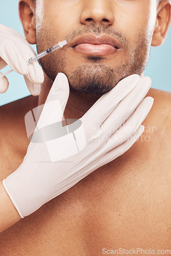 Image of Skincare, botox and lips with a man in studio on a gray background for a plastic surgery injection. Hands, beauty and syringe with a young male patient indoor for an antiaging facial filler closeup