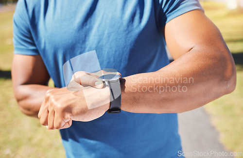 Image of Fitness, stopwatch and man with a watch outdoor for training or running progress at park. Smartwatch on arm of athlete person in nature with time to exercise, start run and check performance goals