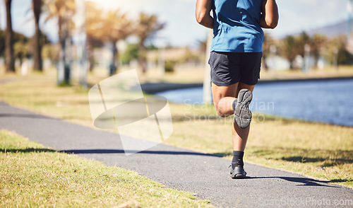 Image of Fitness, legs and man or runner outdoor for exercise, training or running at a park. Closeup and feet of a male athlete in nature for a workout, run and cardio performance for health and wellness