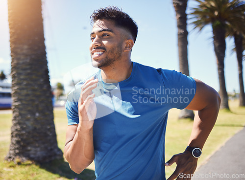 Image of Fitness, running and man outdoor at park for exercise, training or cardio health. Happy Indian male athlete or runner in nature for a workout, run or jog while thinking of goals or performance