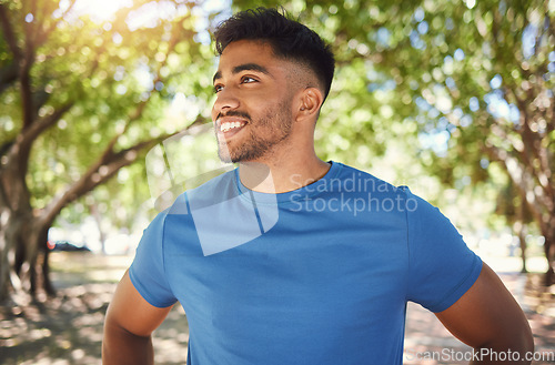 Image of Fitness, smile and man or runner outdoor for exercise, training or running at a park. Happy Indian male athlete in nature or forest for a workout, run and break while thinking of goals or performance