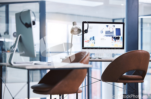 Image of Internet, call center and headset on a computer screen in an empty office space for customer service. Crm, telemarketing and sales or technical support company with contact us website on a desktop