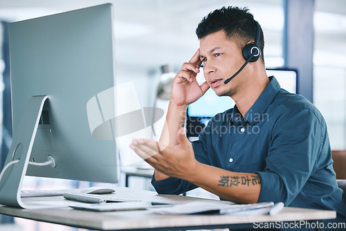 Image of Mental health, businessman with stress and with headset at his computer in his workplace office at a desk. Telemarketing or call center, problem and problem with a male person at his workstation