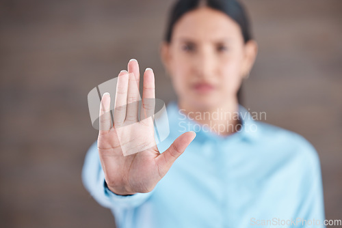 Image of Stop, hand sign and woman with no gesture for sexual harassment and violence in workplace. Business professional, palm and female employee at company with stopping emoji for gender rights at job