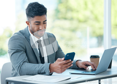 Image of Man with laptop, phone and desk at startup checking email, social media and search on internet with business plan. Online report, networking and businessman in office typing or reading on cellphone.