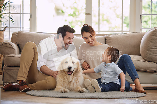 Image of Family laugh, home and dog with child, mom and dad in living room with love in lounge. Animal, pet and mother with father and young kid with happiness in house with golden retriever and care on floor