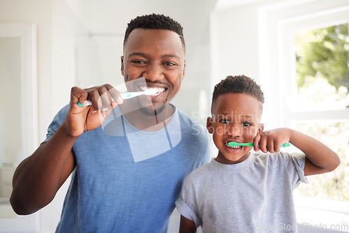 Image of Portrait of a dad brushing his teeth with his child for dental care, health and wellness in the bathroom. Oral hygiene, teaching and young father doing morning mouth routine with his boy kid at home.