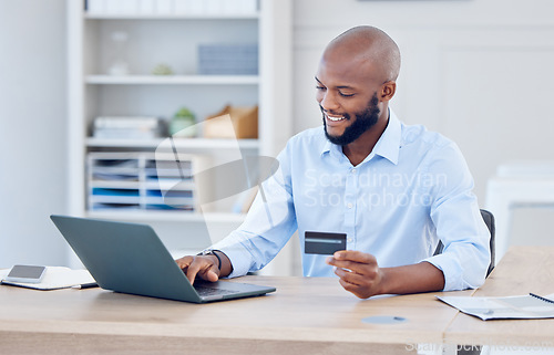 Image of Black man, corporate credit card and laptop with ecommerce and fintech, payment with smile and bank app. Male professional at office with business purchase, online shopping and internet banking