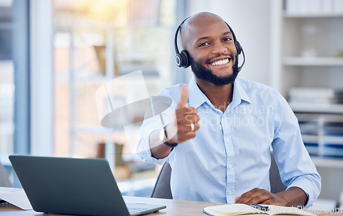 Image of Man at callcenter, thumbs up in portrait and contact us, communication of support and agreement emoji. CRM, customer service and tech, male agent with headset and smile, success and yes hand gesture