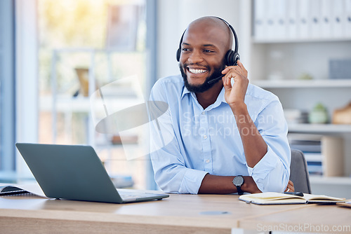 Image of Happy black man, callcenter with phone call and contact us, communication with headset and CRM. Male consultant with smile, customer service or telemarketing with conversation and help desk employee